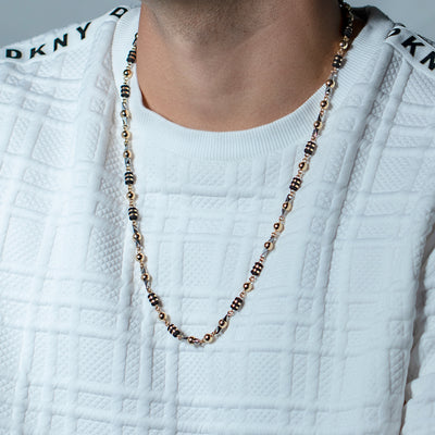 Collar Exclusivo en oro laminado 18k , elaborado con bolas laminadas 6mm doradas a las cuales se le hace técnica de alambrismo artesanal y también se incrustan en pin de acero de joyería 316L, se acompaña todo esto con barriles de neopreno argollados con cinta laminada.